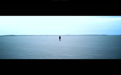 a person standing in the middle of a large body of water