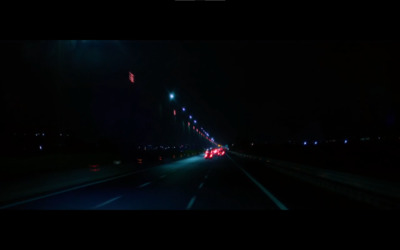 a car driving down a highway at night