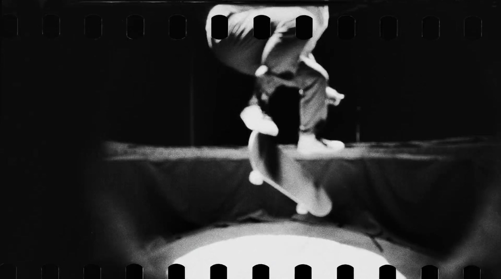 a black and white photo of a person jumping in the air