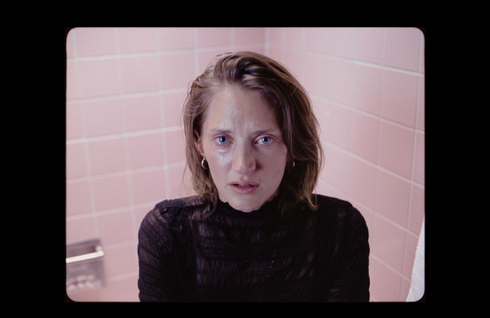 a woman in a black shirt in a bathroom