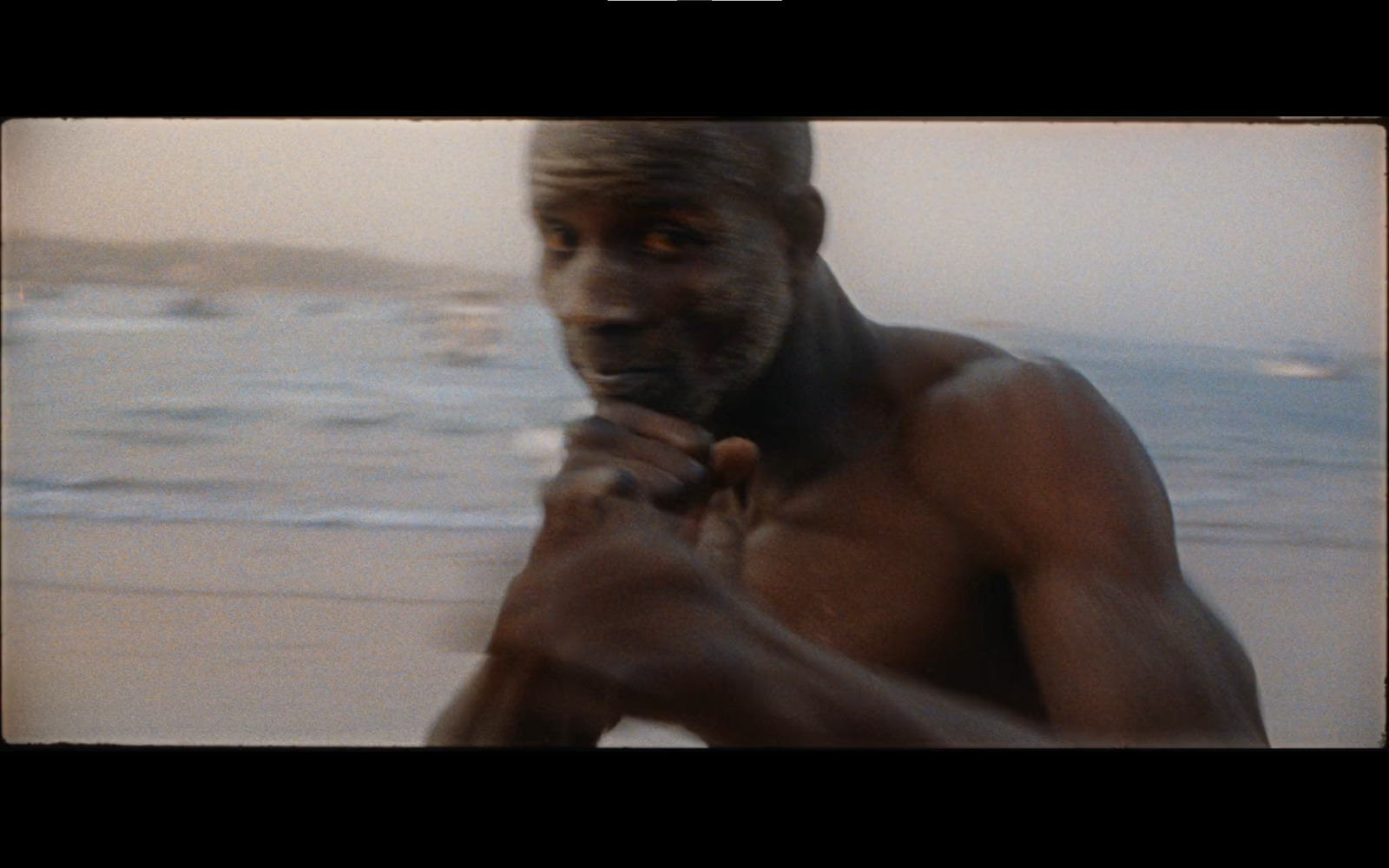 a man standing on a beach next to the ocean