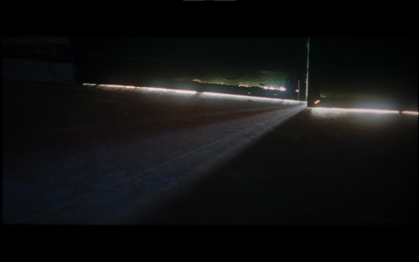 a car driving down a street at night