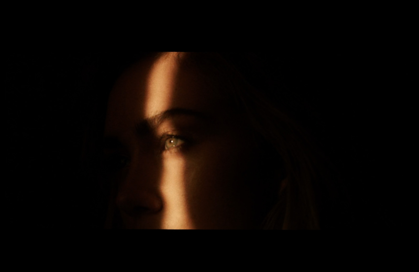 a close up of a person's face in the dark