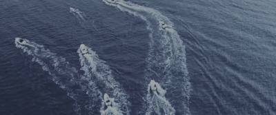 a group of boats traveling across a body of water