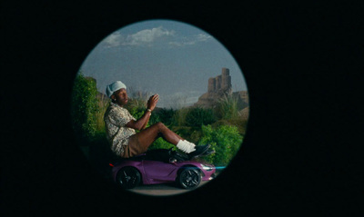 a man sitting on top of a purple car