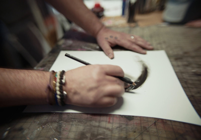 a person cutting a piece of paper with a pair of scissors