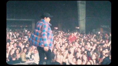 a man standing on top of a stage in front of a crowd