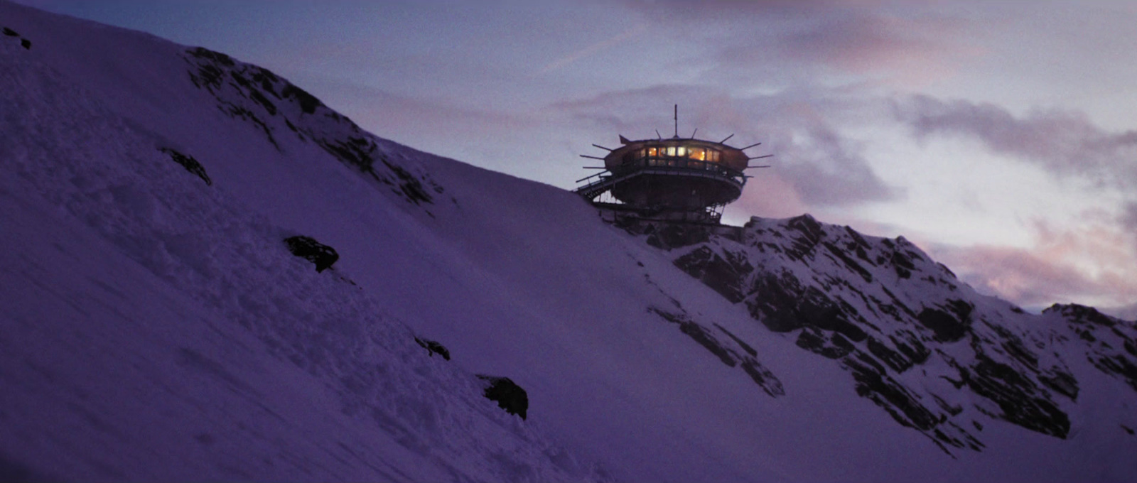 a tower on top of a mountain covered in snow