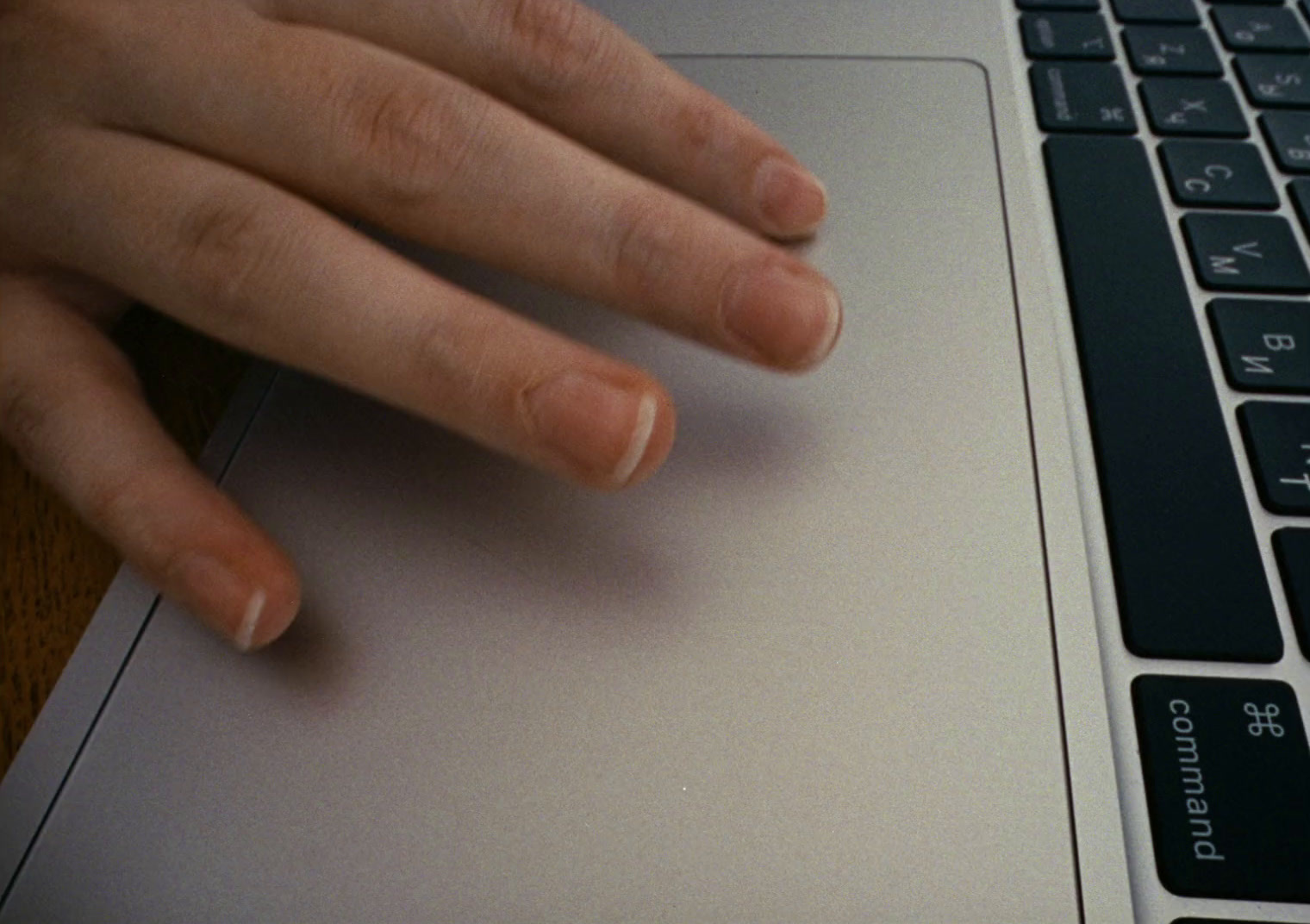 a close up of a person's hand on a laptop keyboard