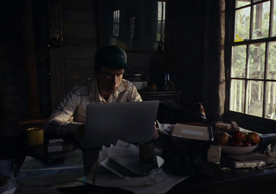 a man sitting in front of a laptop computer