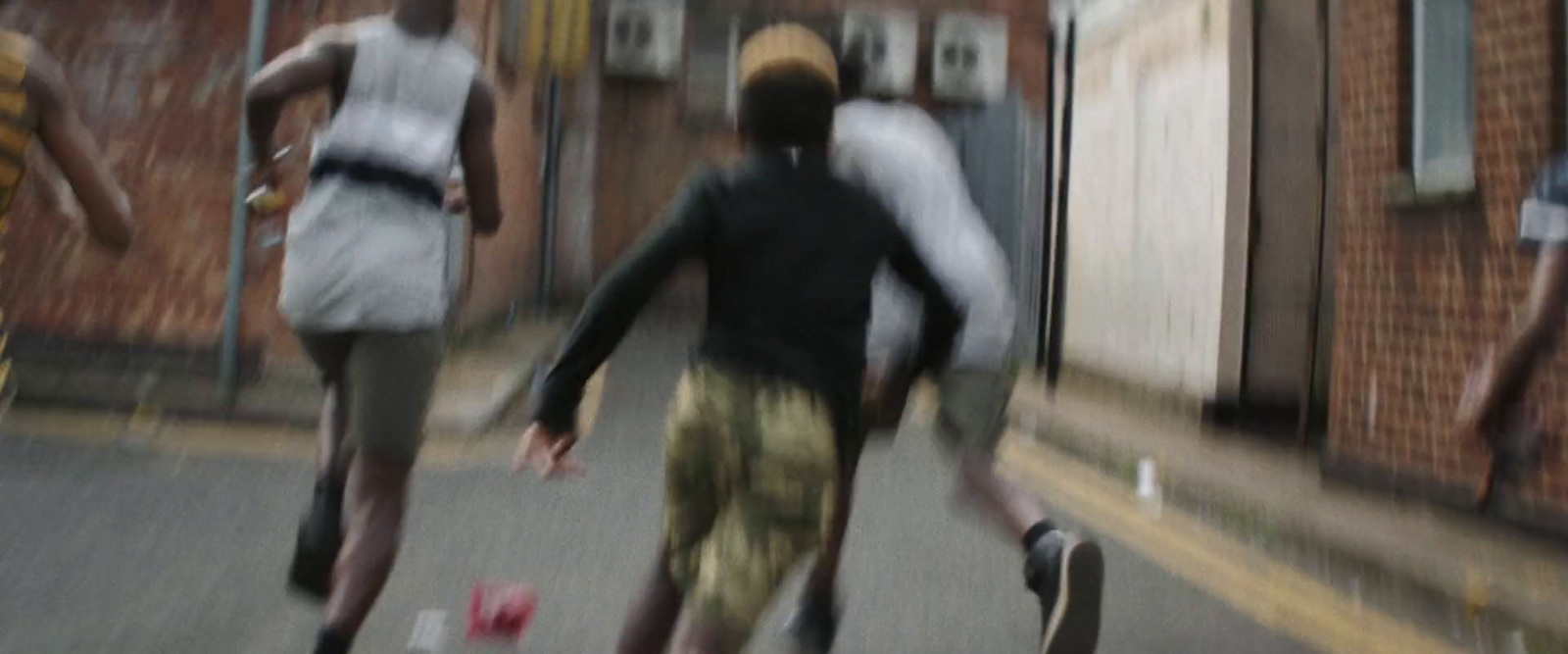 a group of young men riding skateboards down a street