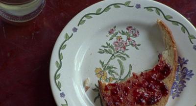 a piece of bread with jam on it on a plate