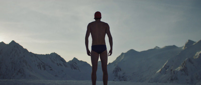 a man standing in front of a mountain range