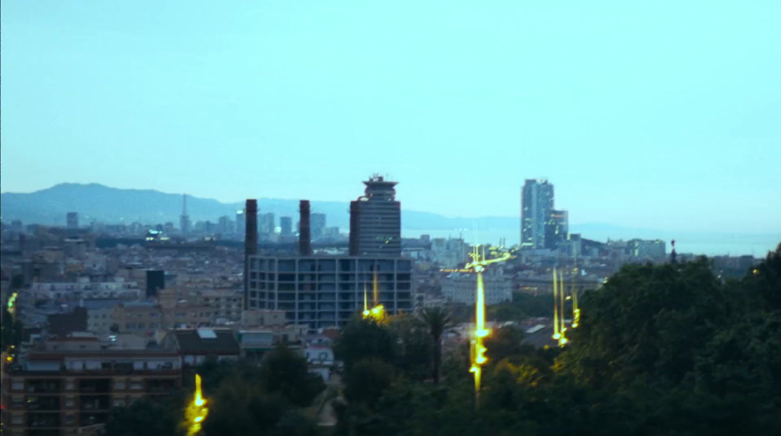 a view of a city at night from a hill