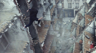 a person jumping off a ledge in a city