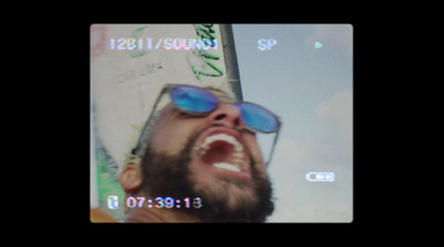 a man with a beard and blue sunglasses