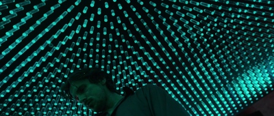 a man standing in front of a lit up umbrella