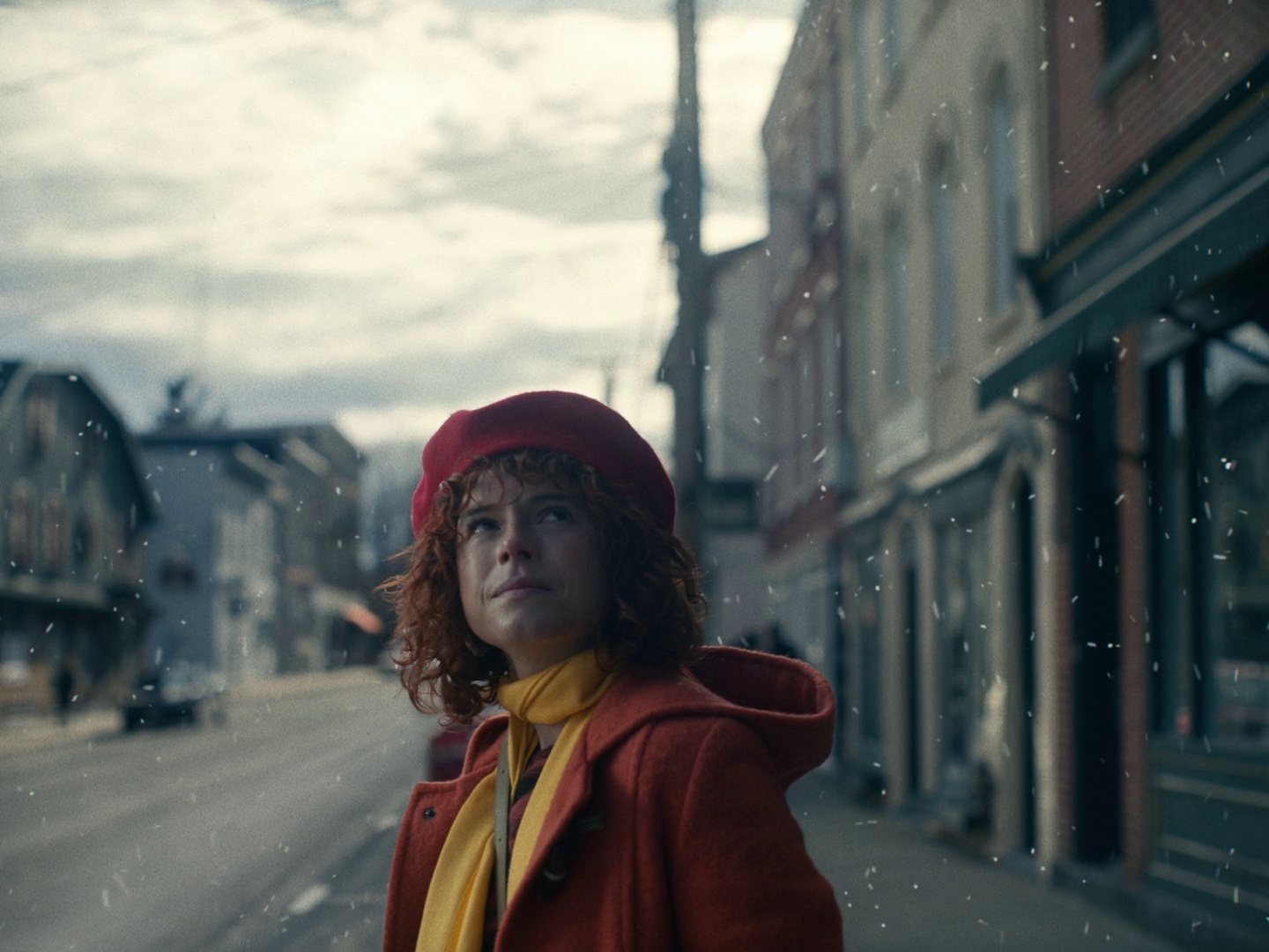 a woman wearing a red coat and a yellow scarf