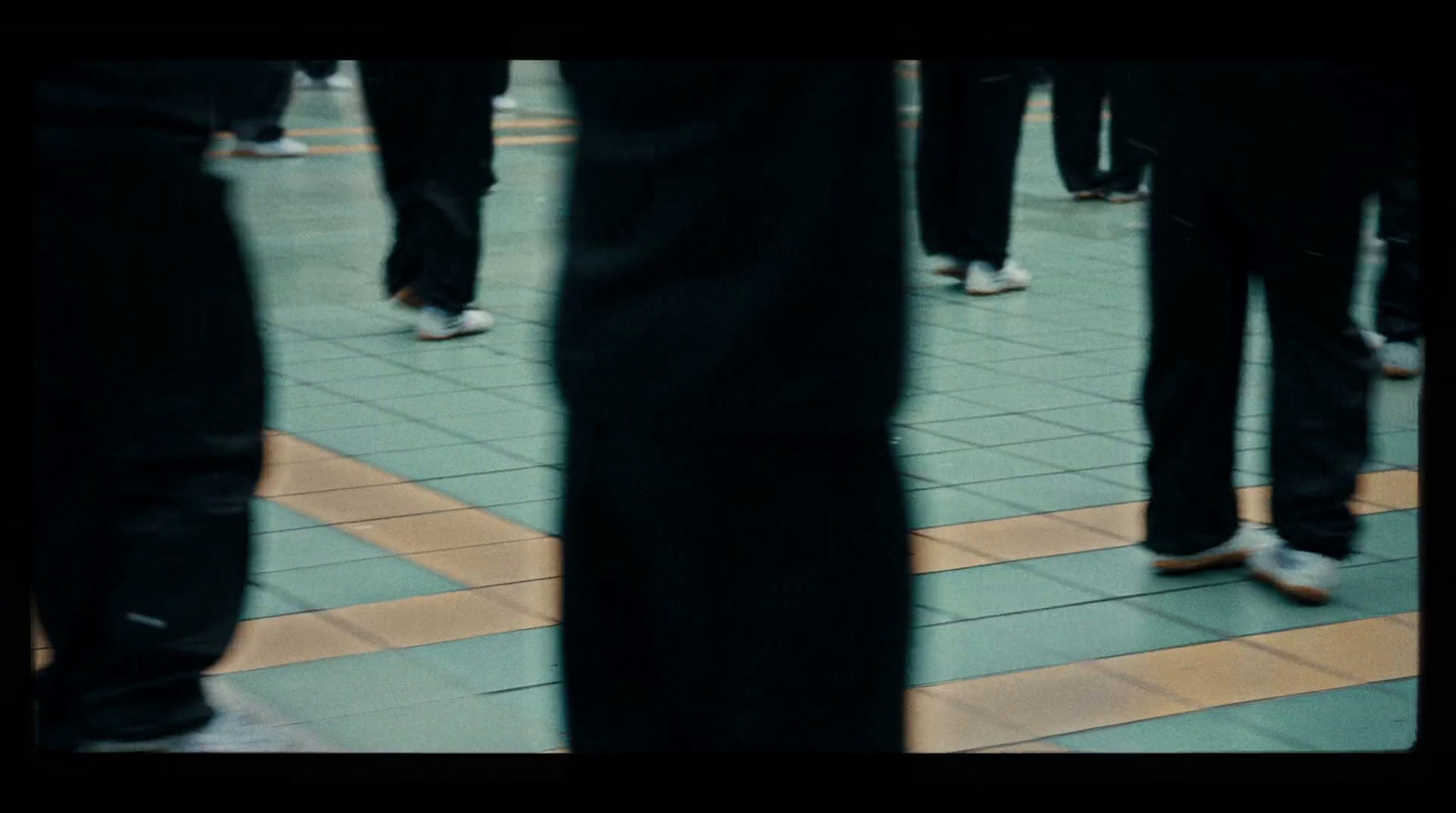 a group of people standing on a tiled floor