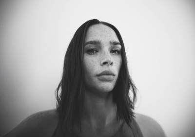 a black and white photo of a woman with freckled hair