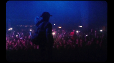 a man standing in front of a crowd at a concert