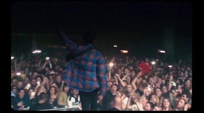 a man standing in front of a crowd at a concert