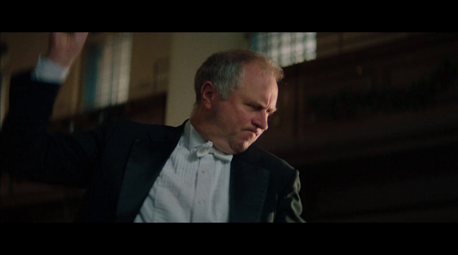 a man in a suit and tie standing in a room