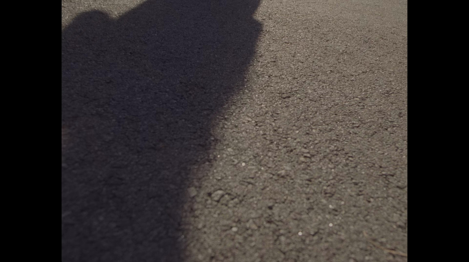 a shadow of a person riding a skateboard