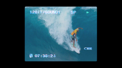 a man riding a wave on top of a surfboard