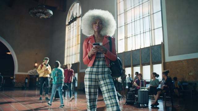 a woman with an afro standing in a lobby