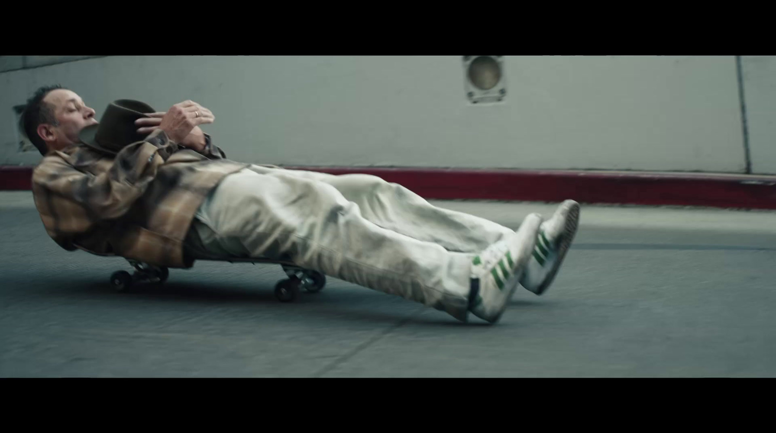 a man laying on the ground on a skateboard