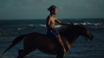 a man riding on the back of a brown horse