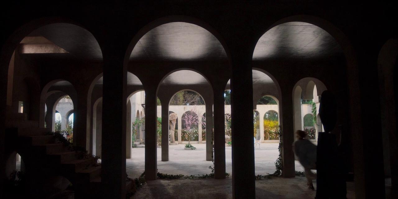 a dark room with arches and arches on the walls