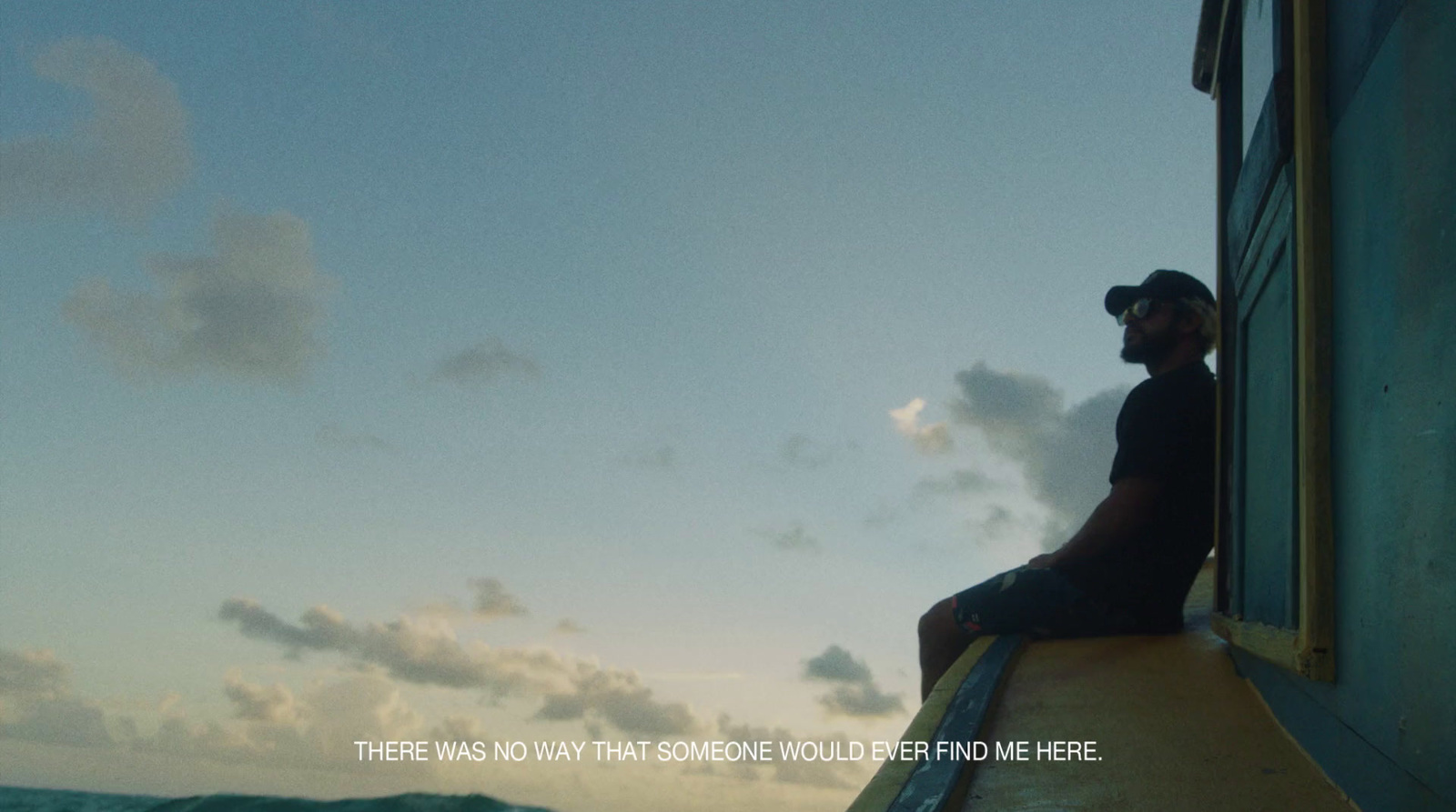 a man sitting on top of a yellow surfboard