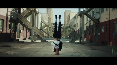 a person doing a handstand in the middle of a street