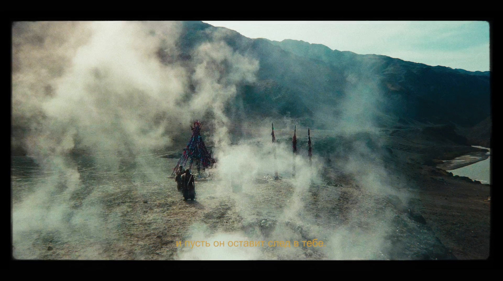 a group of people riding motorcycles down a dirt road