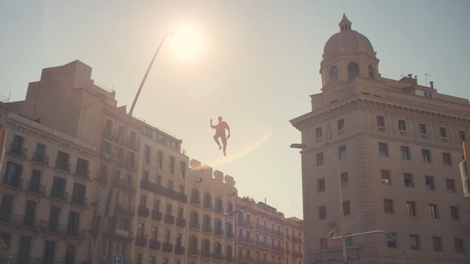 a person is in the air above a city street