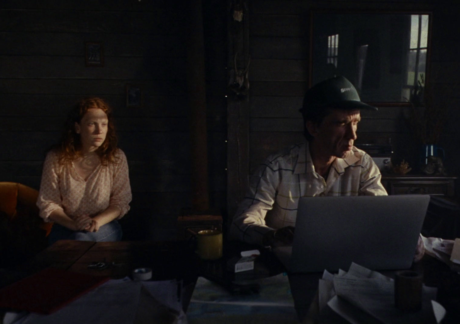 a man and a woman sitting at a table with a laptop