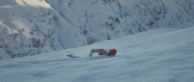 a snowboarder sliding down a snow covered mountain