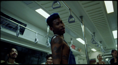 a man with tattoos standing in a room