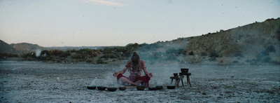 a woman sitting in the middle of a field