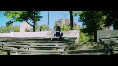 a woman sitting on a bench reading a book