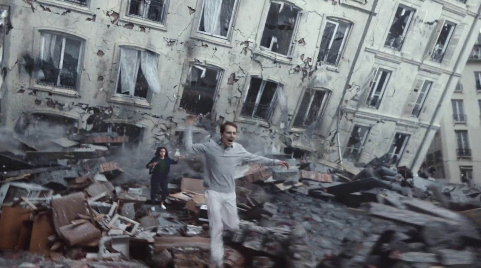 a man standing in front of a pile of rubble