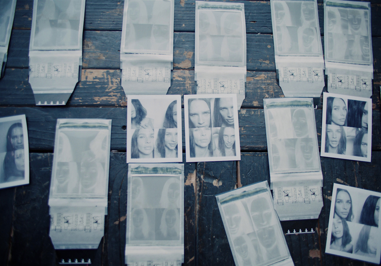 a bunch of pictures of people on a wooden table