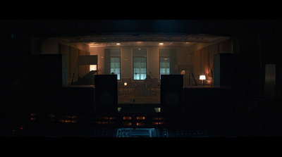 a dimly lit room with speakers in the dark