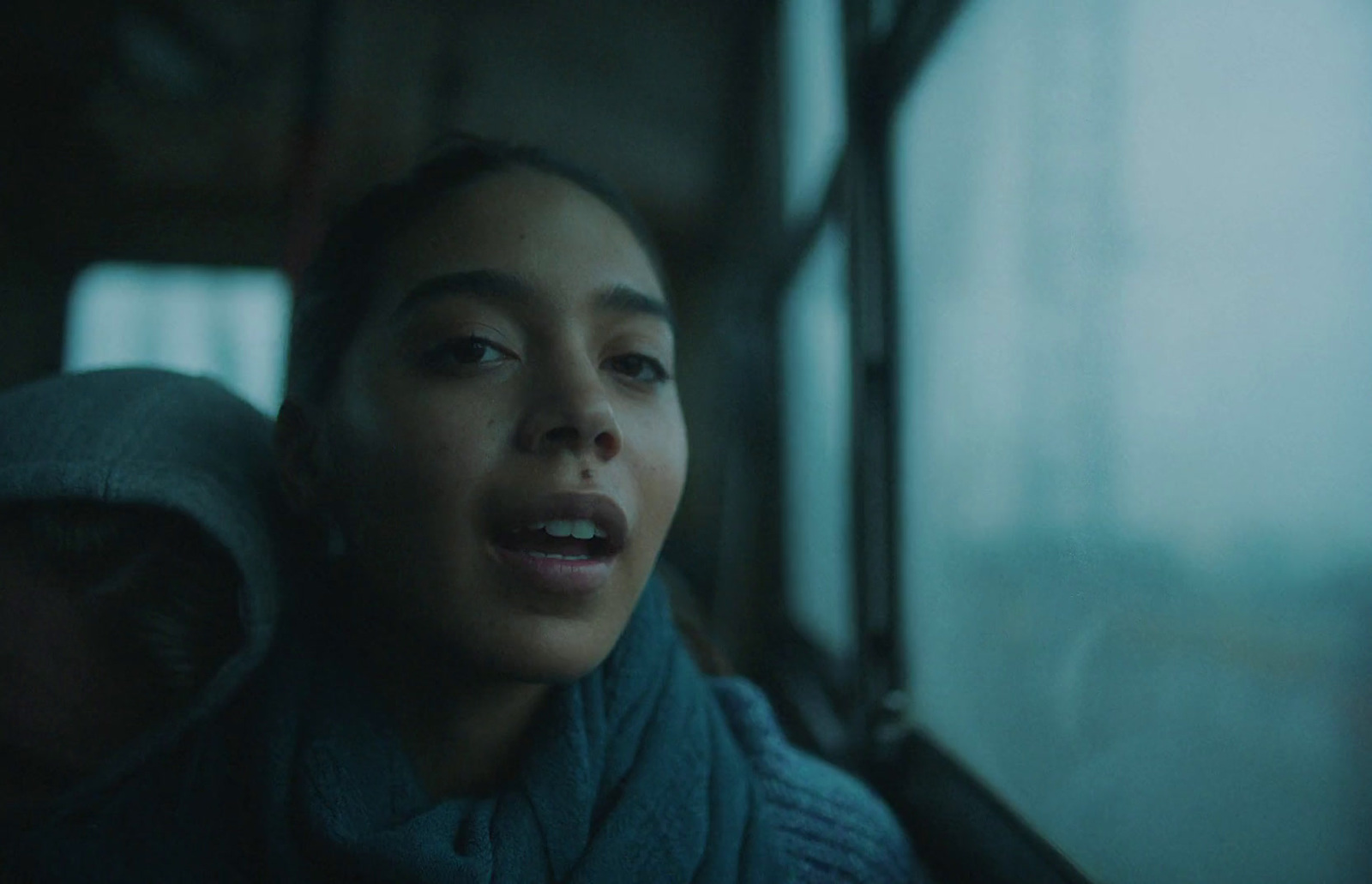 a woman looking out the window of a train