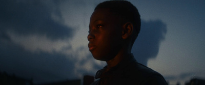 a man standing in front of a building at night