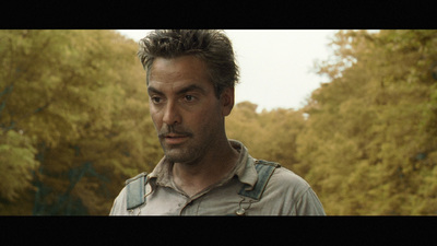 a man standing in front of some trees