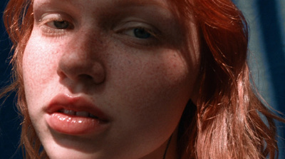 a close up of a woman with freckled hair