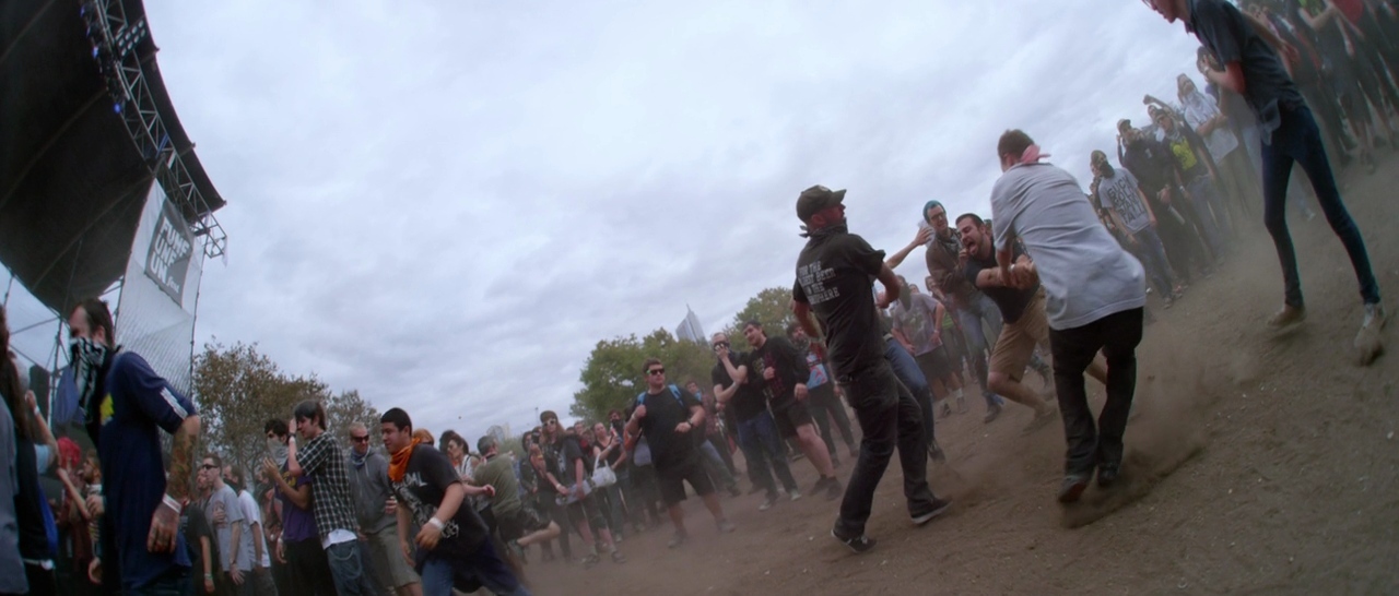 a group of people standing on top of a dirt field